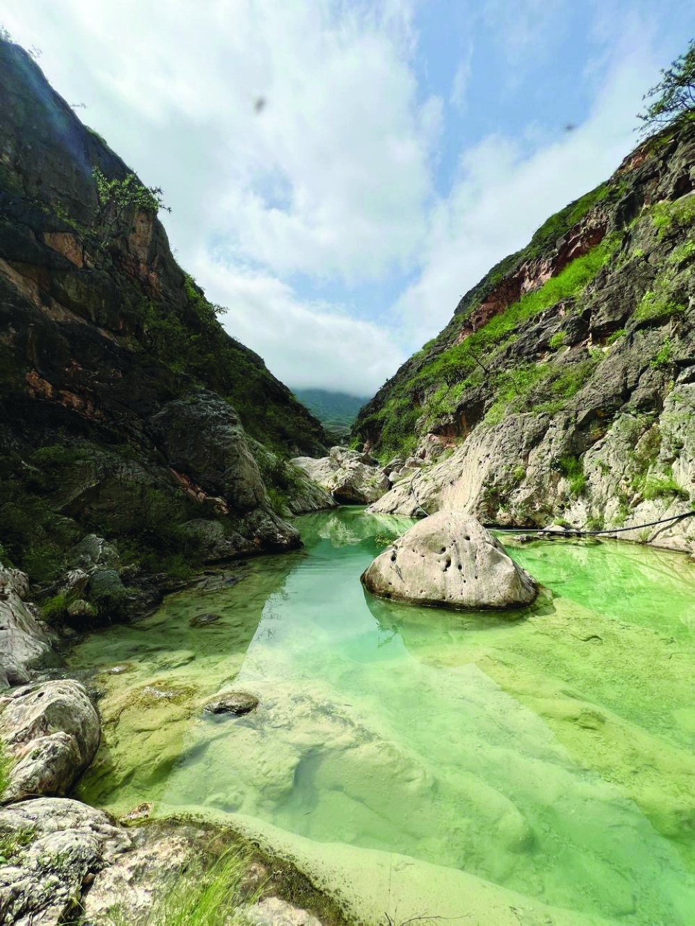 Ain Arzooq emerges amidst Dhofar’s rugged mountainous landscape, offering a secluded glimpse of the governorate’s natural beauty.