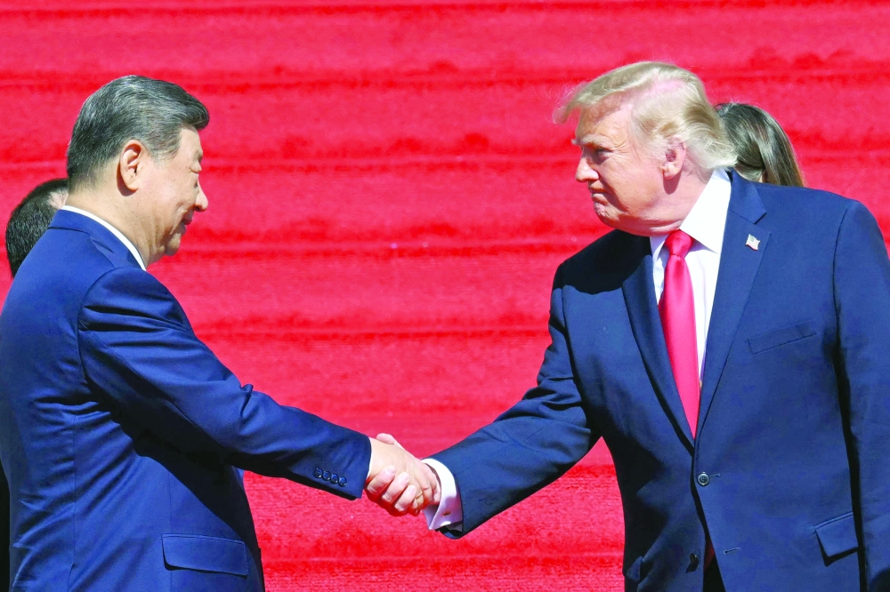 US President Donald Trump shakes hands with China's President Xi Jinping after a visit to the National Archives in Washington, DC. — AFP
