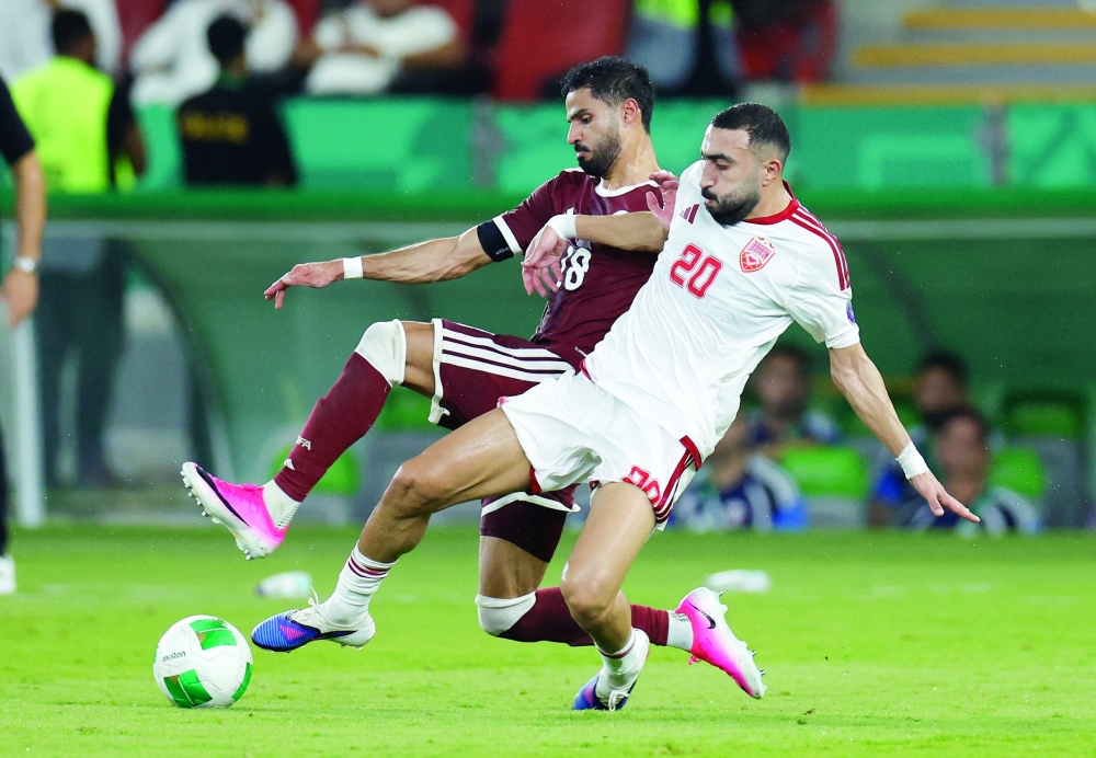 Bahrain's Mahdi al Humaidan in action with Qatar's Sultan al Brake. — Reuters 