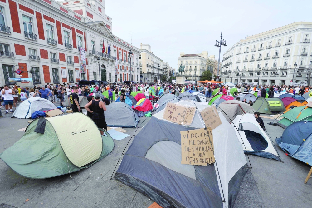 Demonstrators camp with tents to protest against evictions and the housing crisis in front of the Presidency of the Community of Madrid on the Puerta del Sol plaza in Madrid. — AFP