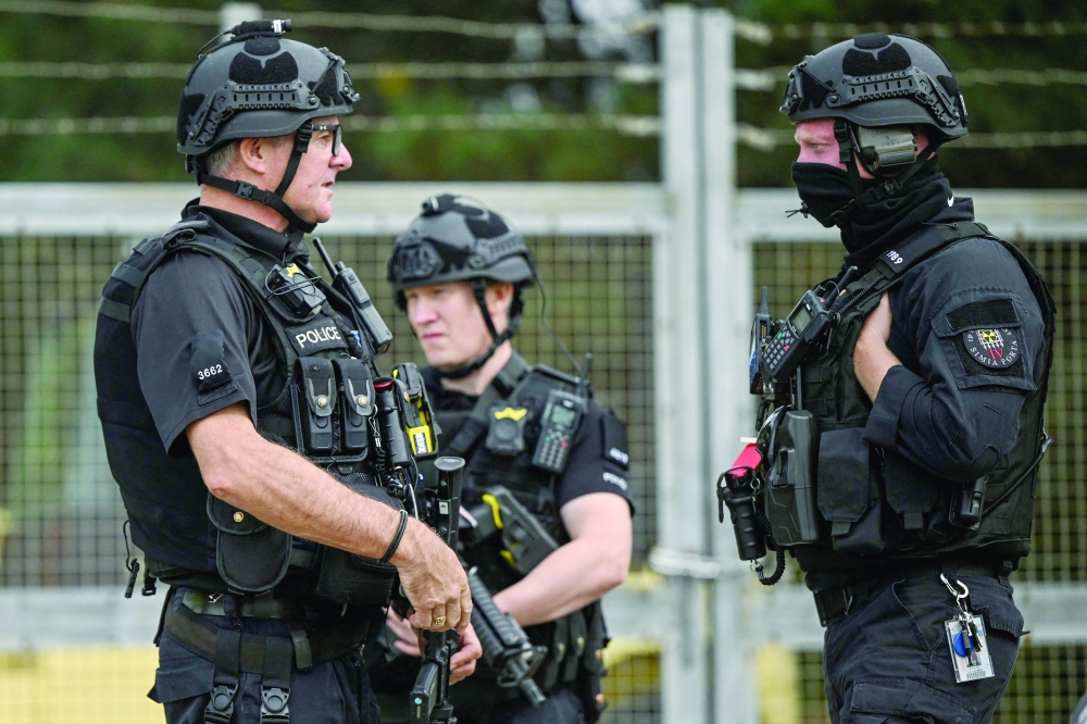 Armed police man a roadblock while posted at an entrance to RAF Fairford base in Fairford, south-west England. — AFP