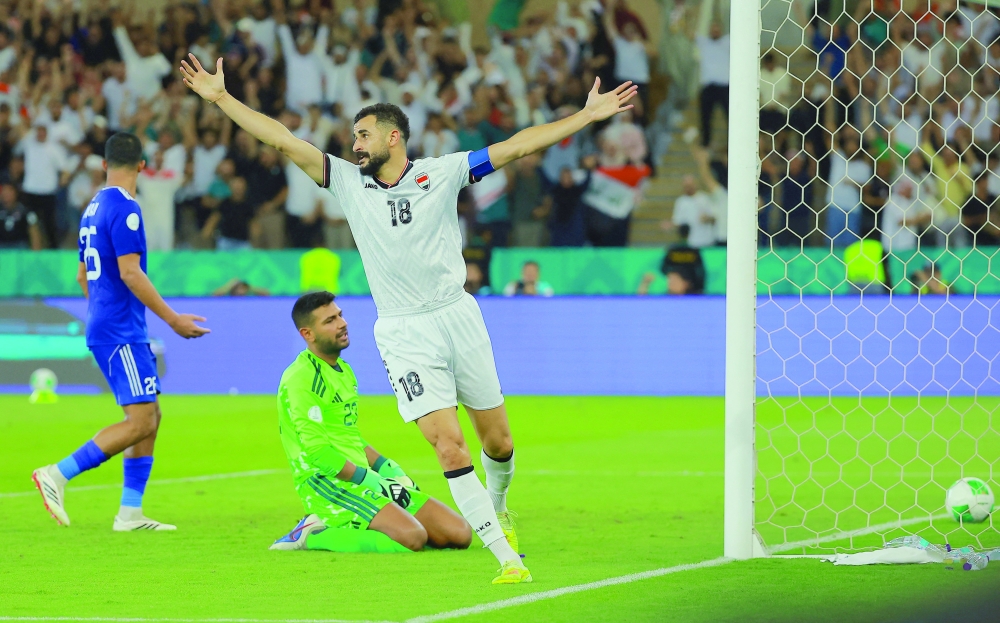 Iraq's Aymen Hussein celebrates after Saif Rasheed scores their second goal. — Reuters