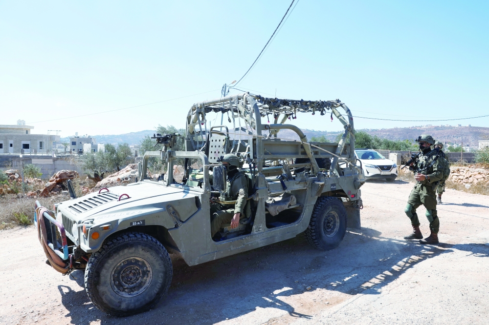 Israeli security forces patrol outside a house that Palestinians in Abu Falah, near Ramallah. — Reuters 