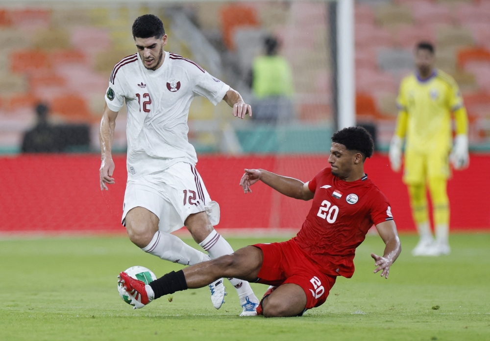 Qatar's Karim Boudiaf in action with Yemen's Tareq Shihab.—  REUTERS