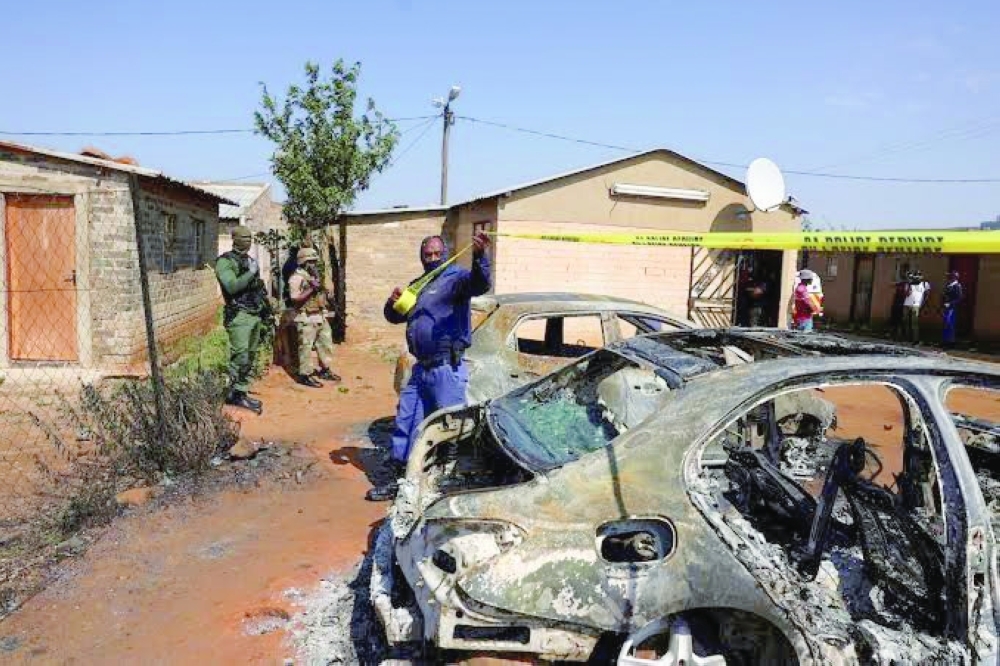 Man standing next to a burning car in Somalia. — Reuters File Photo