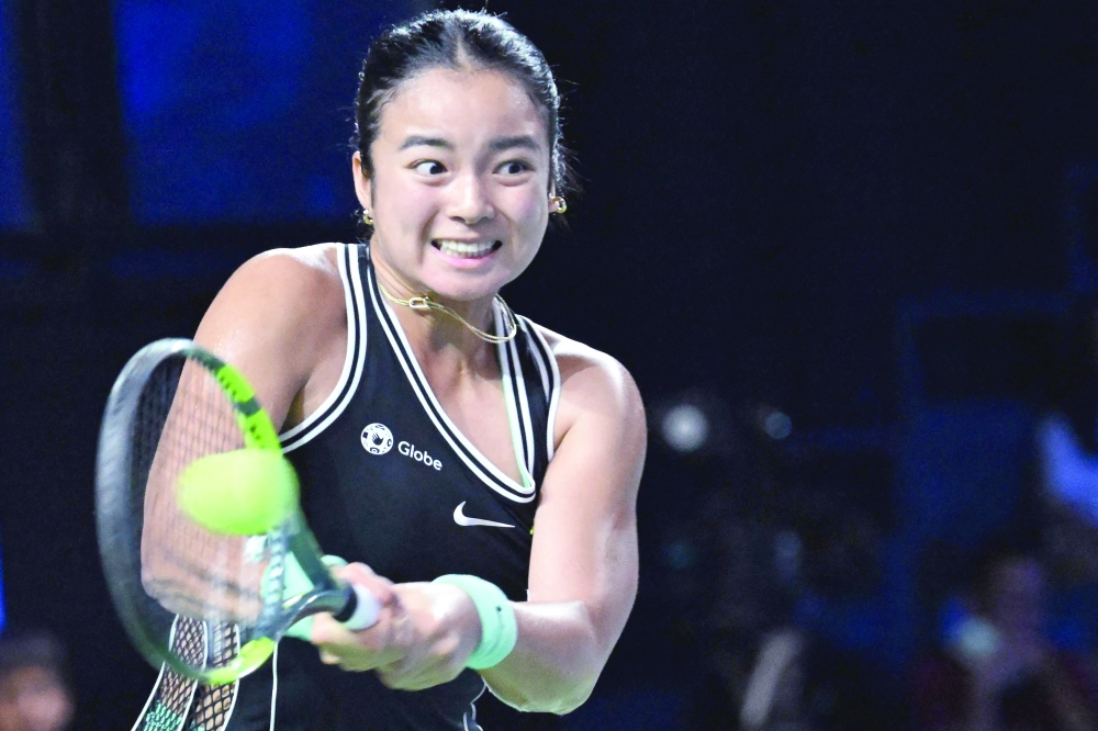 Philippines Alexandra Eala hits a return against Russia's Tatiana Prozorova during the WTA Singapore Open Tennis round 16 in Singapore. — AFP