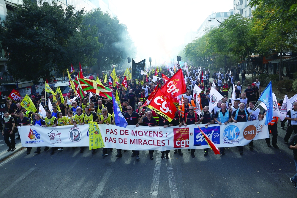French firefighters attend a demonstration calling for more resources and funding following a summer marked by mega-fires, in Paris. — Reuters 