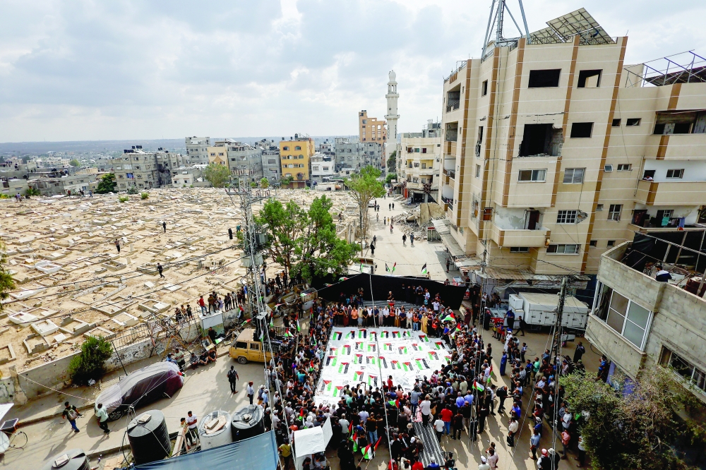 Mourners attend a mass funeral in Gaza. — Reuters Photo Files