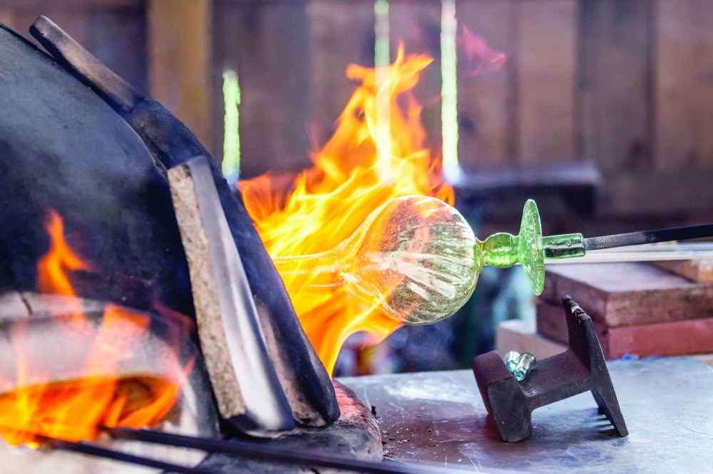 A master glassblower at work at the Roman Villa Borg, recreating the ancient craft that once flourished across the Roman Empire.