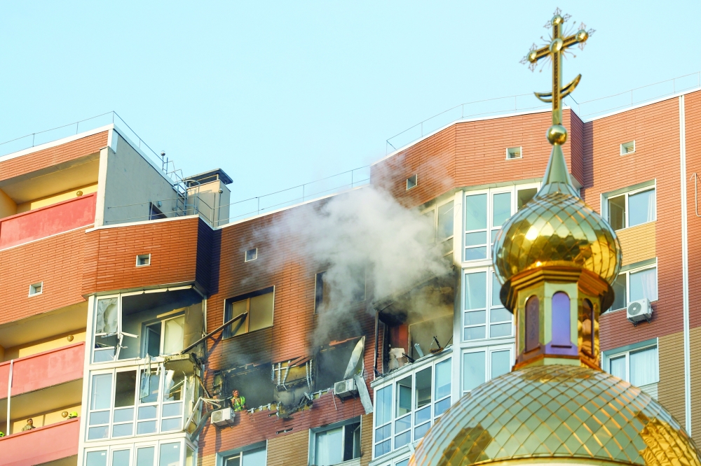 Smoke rises from an apartment building which was hit by a Russian drone strike, amid Russia's attack on Ukraine, in Kyiv. — Reuters