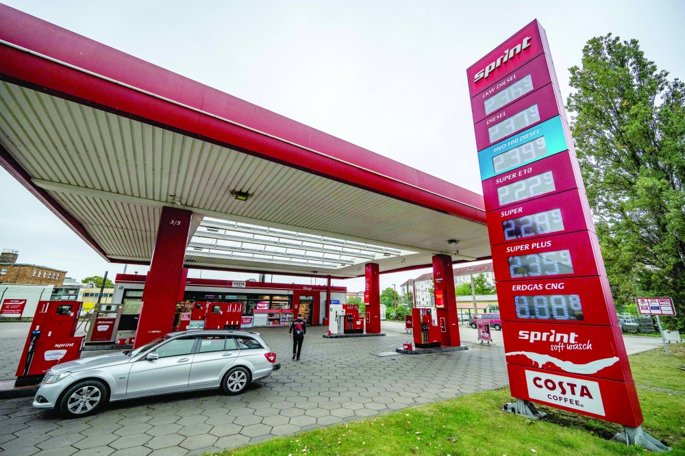 A digital billboard displays fuel prices at a petrol station in Berlin. — AFP