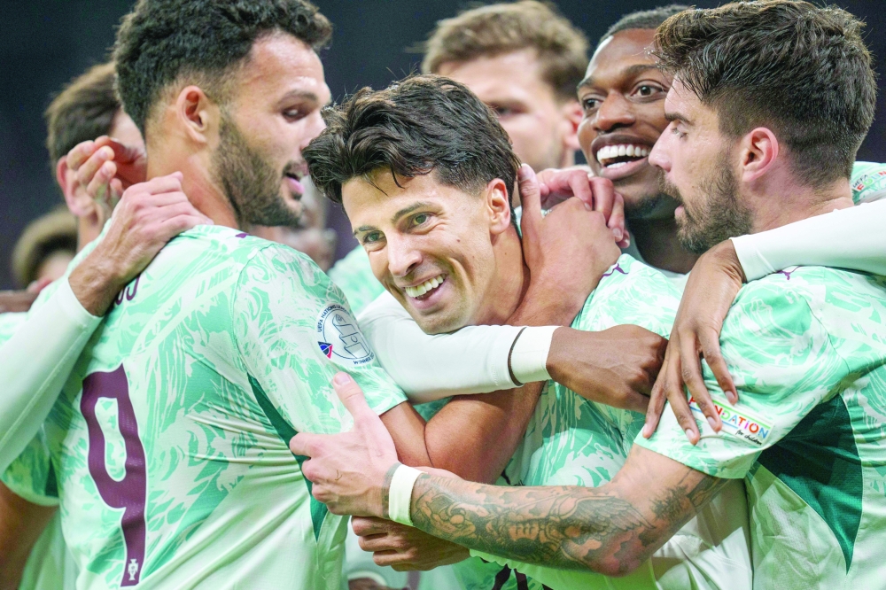 Portugal's defender #20 Joao Cancelo (C) celebrates scoring the opening goal with his teammates during the UEFA Nations League Group A4 match between Denmark and Portugal at Parken stadium in Copenhagen on October 1, 2026.   - Denmark OUT
 (Photo by Liselotte Sabroe / RITZAU SCANPIX / AFP)
