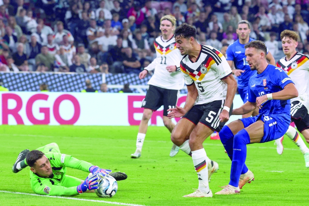 Serbia's goalkeeper #01 Djordje Petrovic (L) prevents Germany's midfielder #05 Aleksandar Pavlovic from scoring during the UEFA Nations League Group A2 between Germany and Serbia at the Allianz Arena in Munich, southern Germany on October 1, 2026. (Photo by Karl-Josef HILDENBRAND / AFP)
