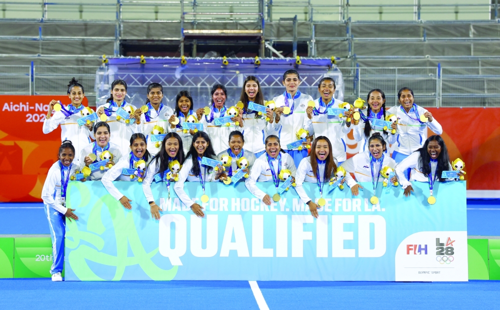 Women's hockey gold medallists India pose with a banner after qualifying for the LA 2028 Summer Olympics at Kakamigahara, Japan. — Reuters