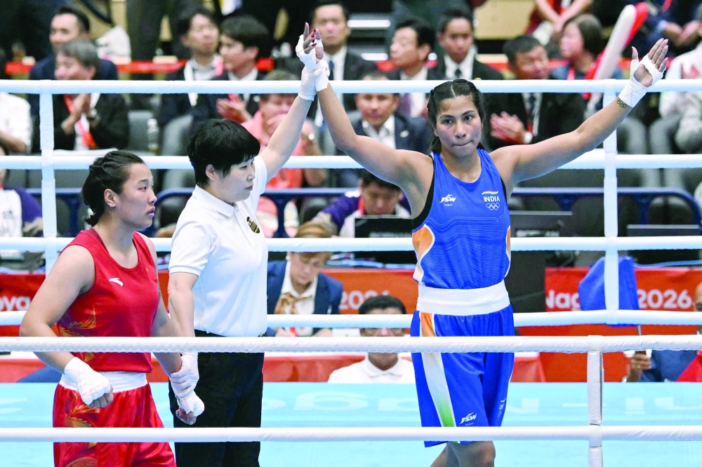 India's Lovlina Borgohain (blue) celebrates her victory against China's Bao Ziyi in the women's 75kg gold medal boxing bout during the 2026 Asian Games at Nishio Gymnasium in Nishio on October 2, 2026. — AFP
