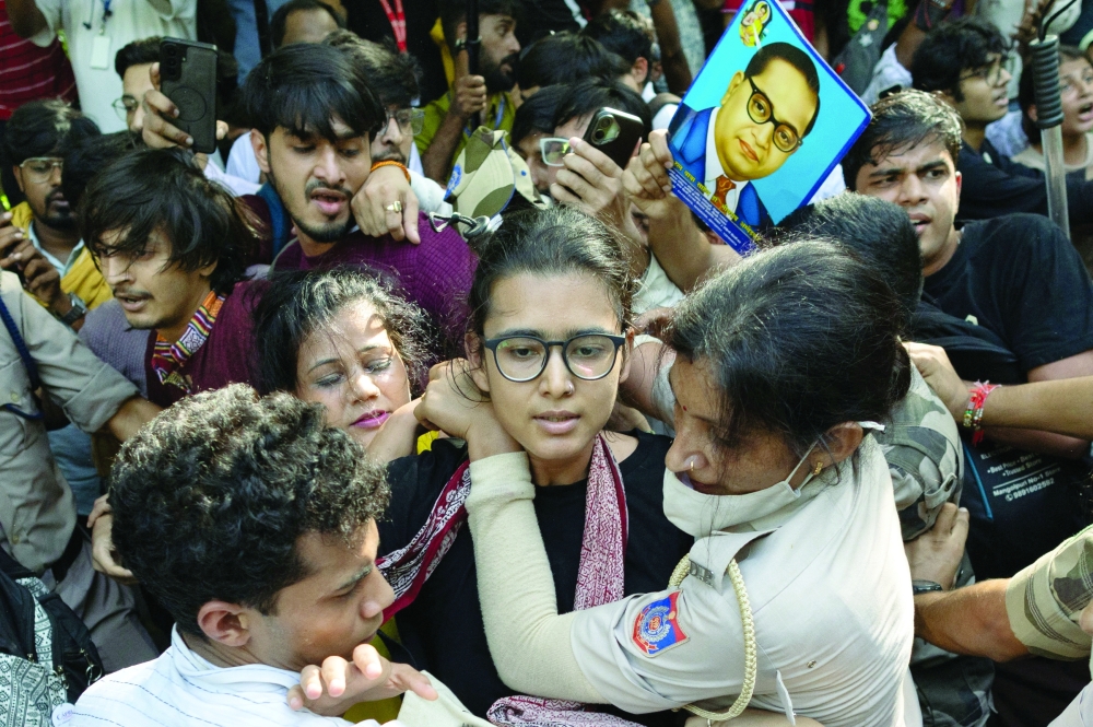 Neha Bora, National President of the All India Students' Association (AISA), is detained by police in New Delhi. — Reuters