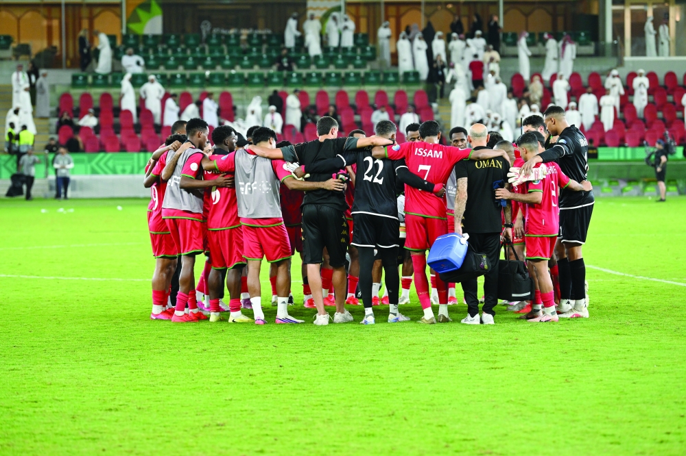 Oman players gather on the pitch following the defeat. — Abdulwahid al Hamadani