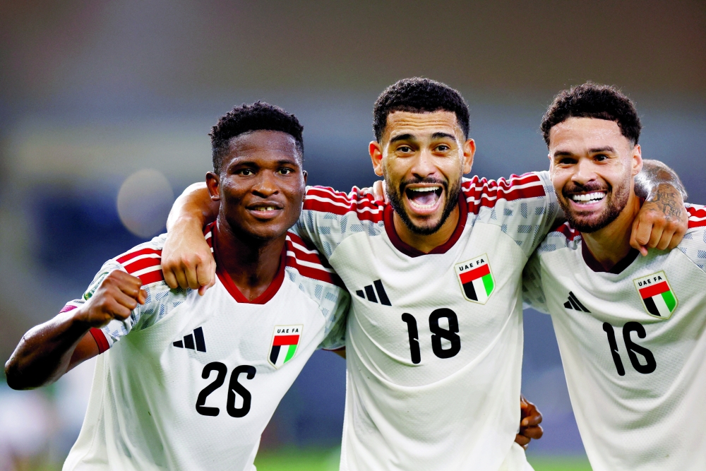 United Arab Emirates' Oumar Camara celebrates scoring their first goal with Luciano Pereira and Marcelo Meloni. — Reuters