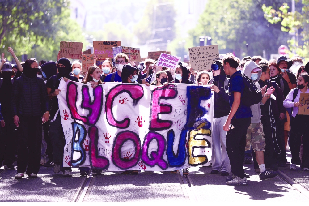 Demonstrators hold a banner reading "high school blocked" during student protests in Lyon. — AFP