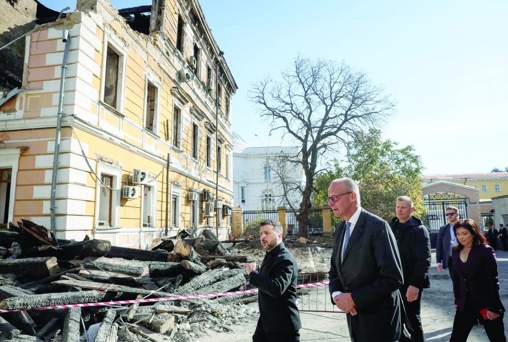 Ukraine's President Volodymyr Zelenskiy and German Chancellor Friedrich Merz visit the site of an administrative building of Ukraine's National Academy of Sciences hit during recent Russian drone strikes in Kyiv. — Reuters 