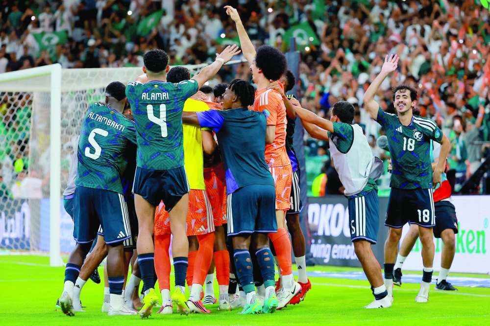Saudi Arabia's Mohammed al Owais celebrates with team-mates after the match.— Reuters
