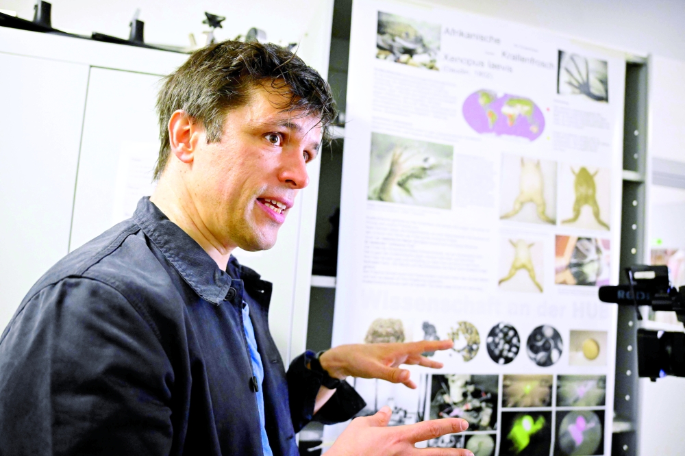 German scientist Matthias Prigge speaks at Peter Hegemann's laboratory at Humboldt University in Berlin. — AFP