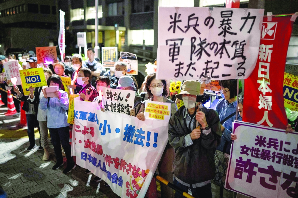 People protest in front of the Prime Minister's Office in Tokyo on Monday against the killing of a woman in Okinawa allegedly committed by a US Marine. — AFP
