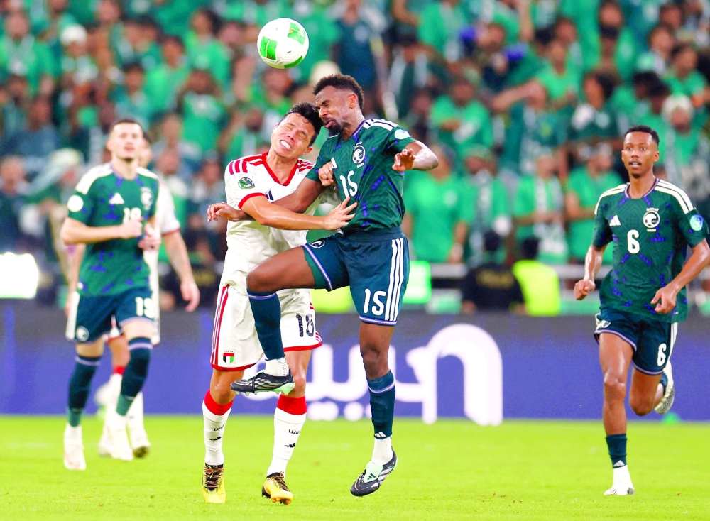 Saudi Arabia's Abdullah Al Khaibari in action with United Arab Emirates's Luan Pereira. — Reuters