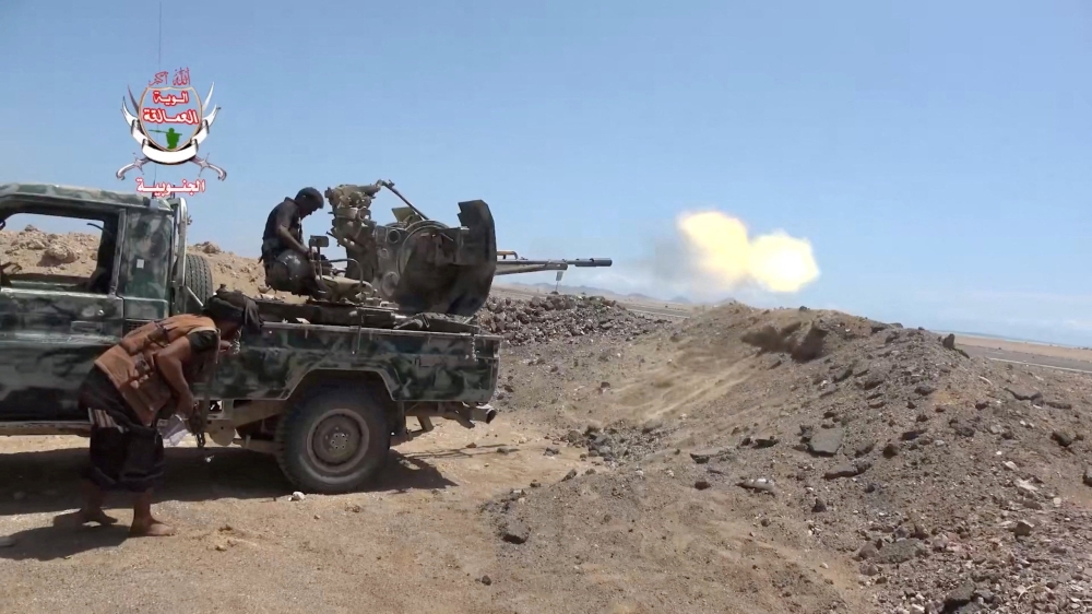 A pro-Saudi-backed Yemeni government fighter fires a vehicle-mounted weapon during what government forces say was an advance against the Iran-backed Houthis, near Dhubab, Taiz Governorate, Yemen