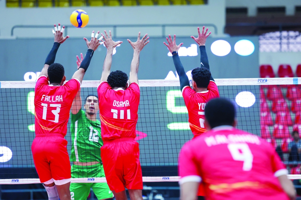 Oman players block a smash from Algeria during their opening match at the 24th Arab Men’s Volleyball Championship in Amman.