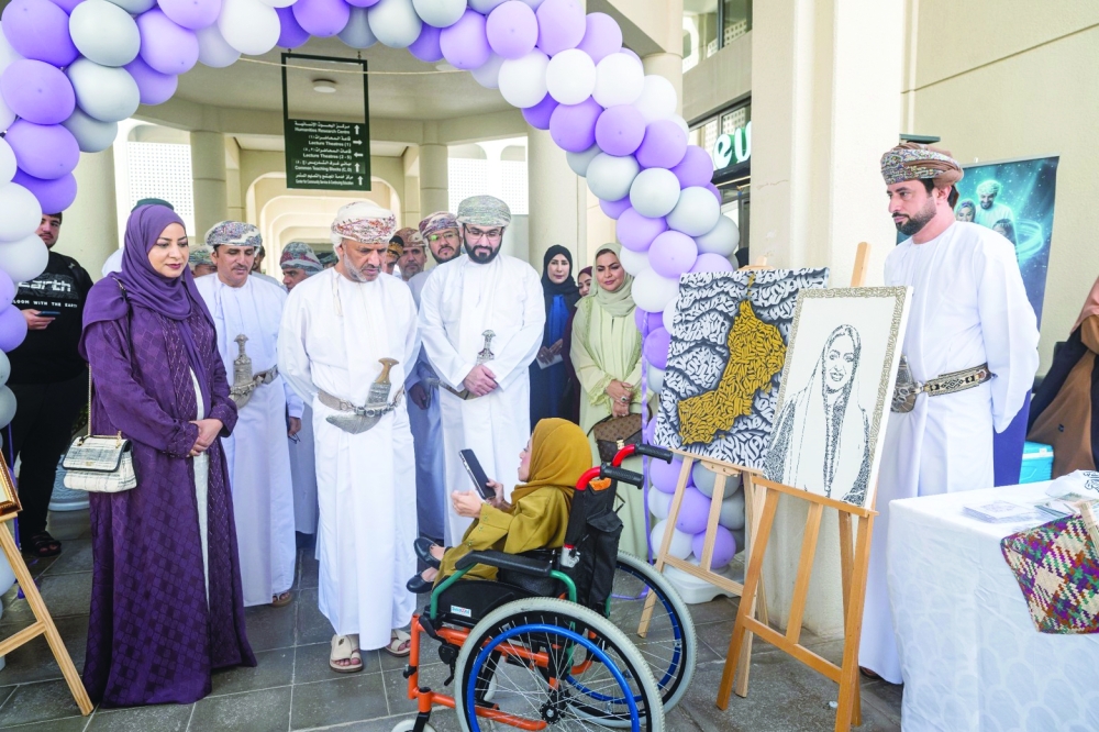 Officials tour an exhibition of student artwork on the sidelines of the campaign launch at SQU. — ONA