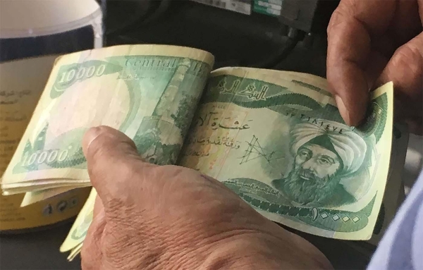 Iraq central bank devalues dinar after Middle East war hurts oil exports