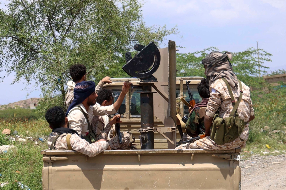 Saudi-backed Yemeni government forces ride in the back of a military truck at the Jabal Han front west of the city of Taiz following fierce battles earlier in the day as Yemen's Houthis reportedly attempted to seize control of the main route between the inland city of Taiz and the coastal city of Aden, on October 3, 2026. Yemen's Iran-backed Houthis on October 4, 2026, cut a vital supply route linking Taiz with Aden -- the interim capital of the internationally recognised government -- according to four security sources.  The Houthi advance follows days of heavy fighting in and around the city of Taiz between the group and government forces.