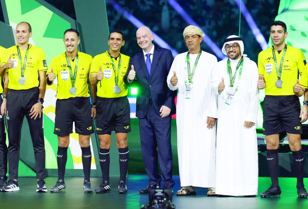 Fifa President Gianni Infantino with the match referees during the trophy ceremony of the Gulf Cup in Jeddah. — Reuters