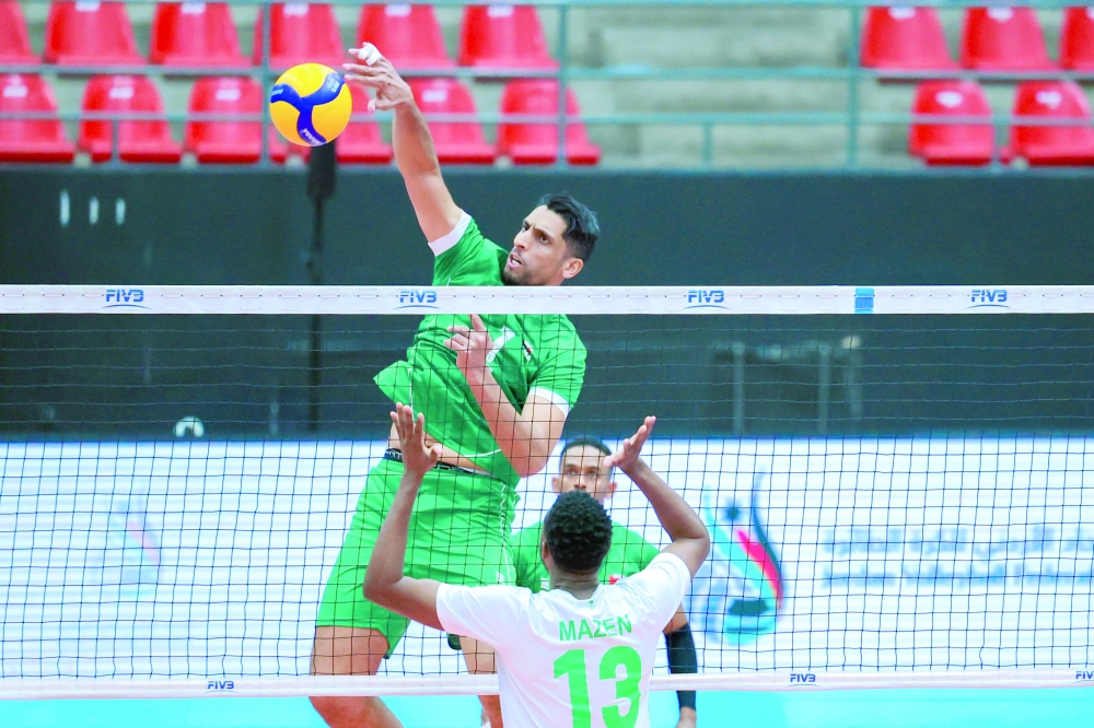 An Oman player makes a smash against Saudi Arabia in Amman.