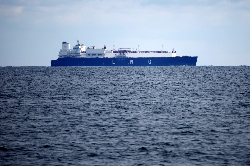 An LNG carrier sails past an offshore wind farm off the coast of western France. — Reuters file photo
