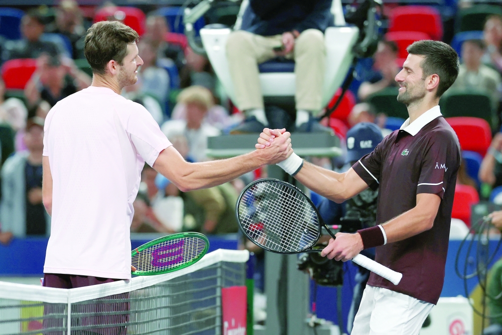 Poland's Hubert Hurkacz shakes hands with Serbia's Novak Djokovic after winning his round of 64 match at Shanghai Masters. — Reuters