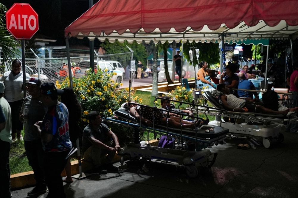 People and patients gather outdoors after being evacuated from Hospital Aquilino Tejeira, after an earthquake struck near the southern coast of Panama, in Penonome, Panama, October 9, 2026. 