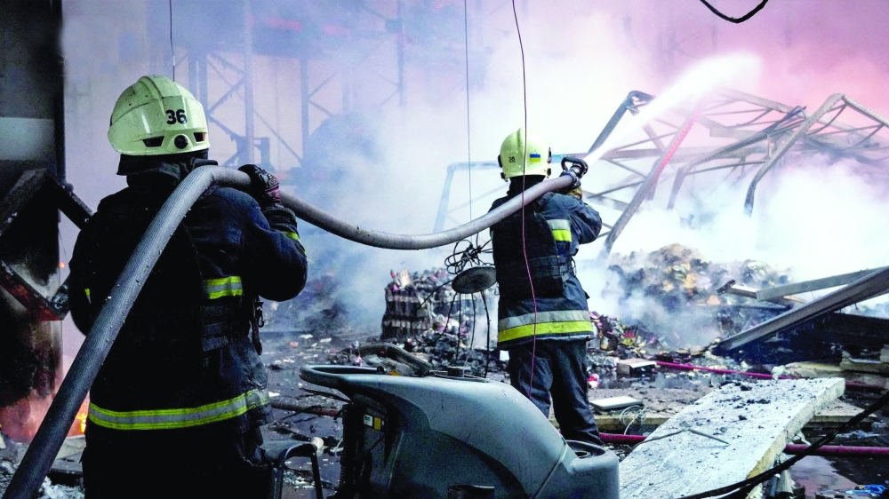 Firefighters work at a site of a destroyed warehouse hit during a Russian drone strike in Kyiv region. — Reuters 