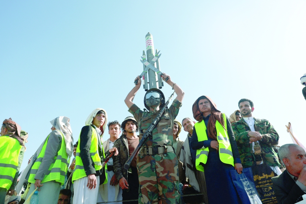 An Ansar Allah supporter holds a mock missile as he joins a rally in Sanaa, Yemen. — Reuters