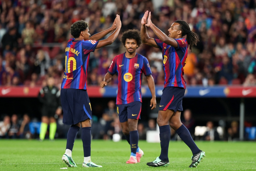 Barcelona's French defender #23 Jules Kounde (R) celebrates scoring his team's third goal with teammate  