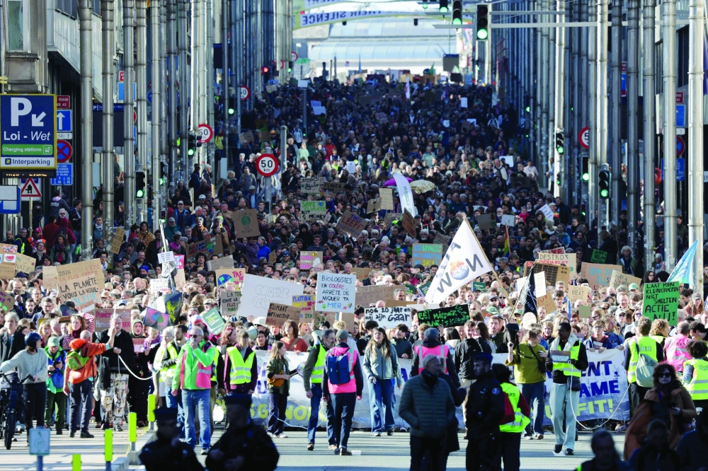 Protesters take part in the Climate March 2026, organised by the Climate Coalition, in Brussels, on October 11m 2026. The Climate Coalition demands the federal and regional governments to stop subsidising polluting industrial activities in Belgium and levy higher taxes on these companies.  - Belgium OUT