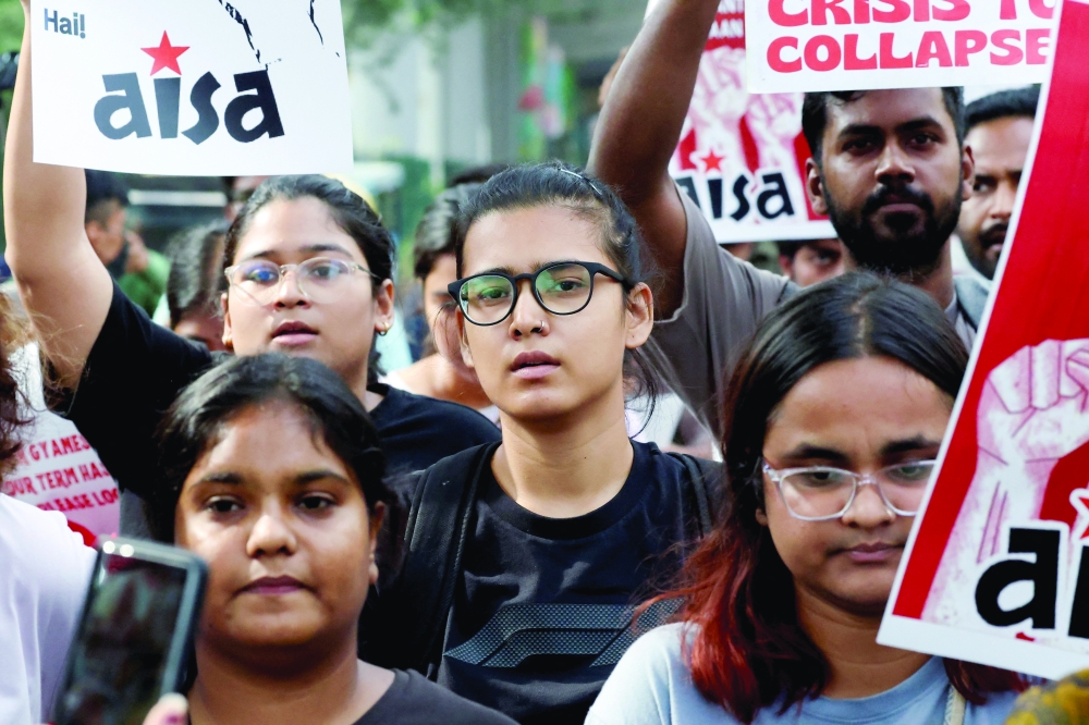 People look on during a protest seeking the resignation of India's Chief Election Commissioner Gyanesh Kumar, in New Delhi. — Reuters