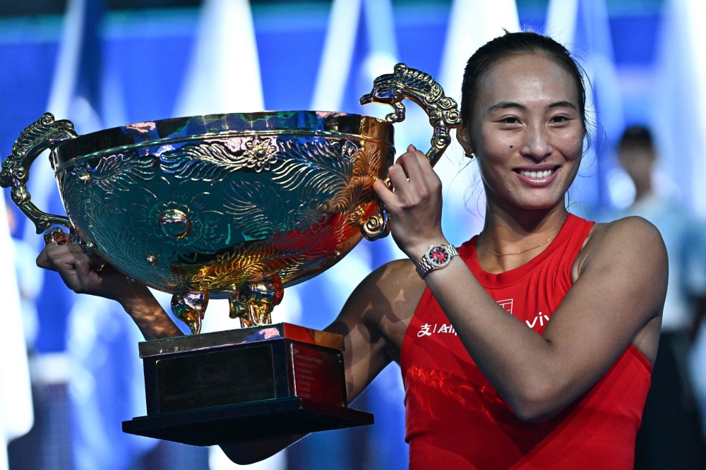 China’s Zheng Qinwen celebrates with the trophy after beating Russia’s Mirra Andreeva in the women’s singles final  
