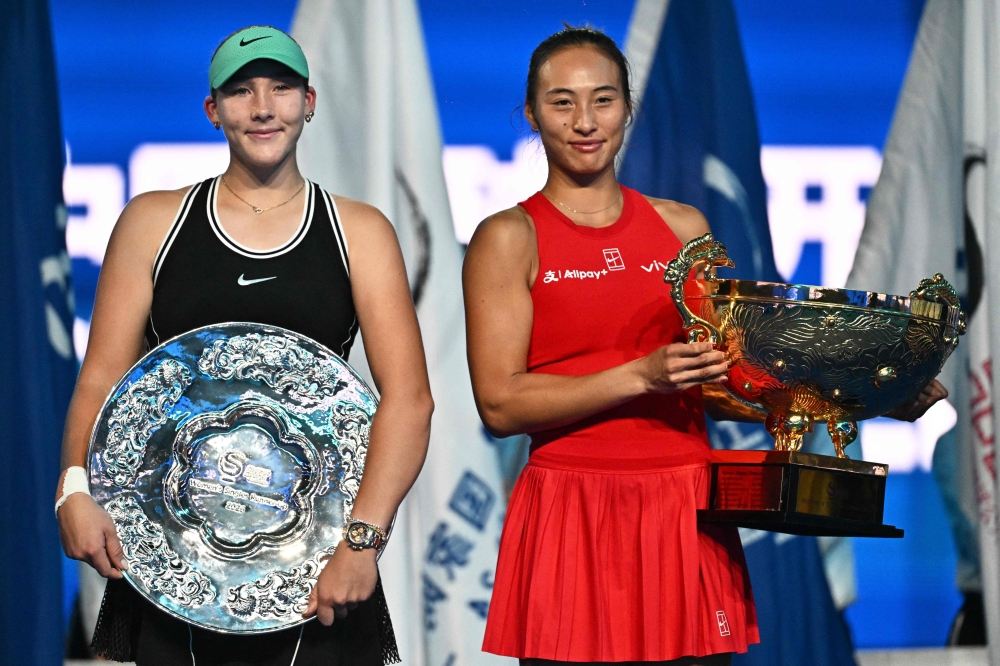 Winner China's Zheng Qinwen (R) and runner-up Russia's Mirra Andreeva pose with their trophies after the women’s singles final  