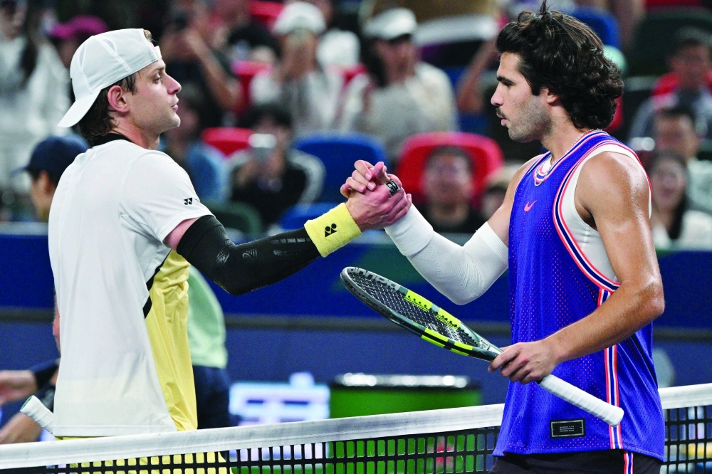 Belgium's Zizou Bergs (L) shakes hands with Spain's Carlos Alcaraz at the end of their men's singles match at the Shanghai. — AFP