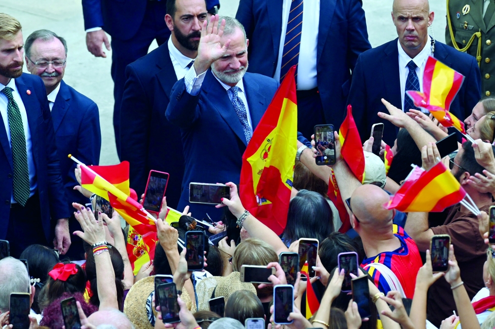 Spain's King Felipe VI greets people upon his arrival in the Spanish North African enclave of Ceuta. — AFP