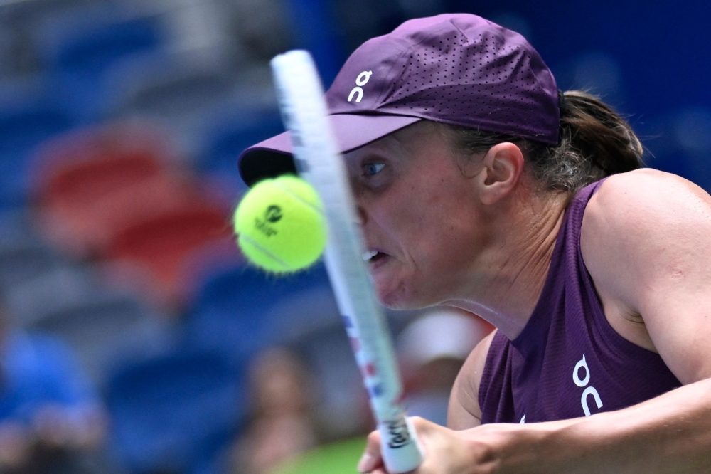 Poland’s Iga Swiatek hits a return to Poland's Magdalena Frech  