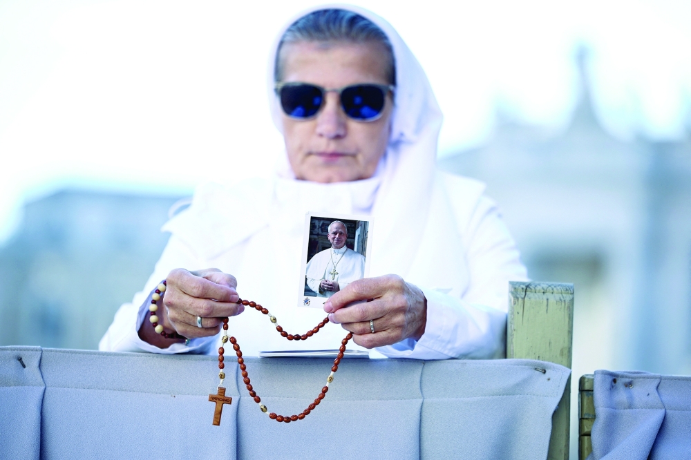 A nun holds a picture of Pope Leo on the day of a mass including special prayers for his health in St Peter's Square at the Vatican. — Reuters 