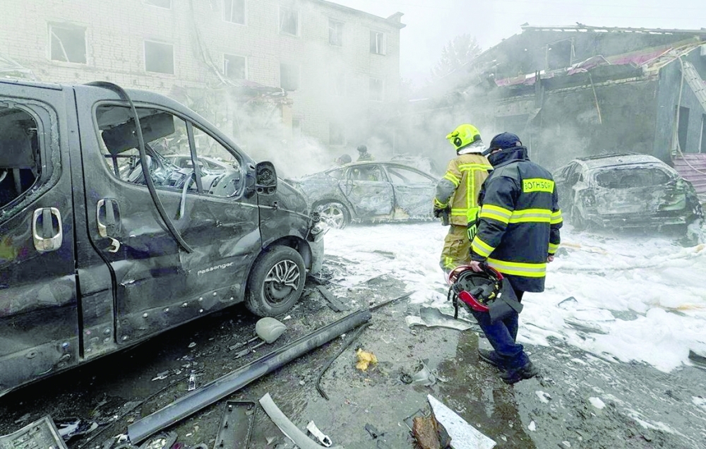 Rescuers work at a site of a Russian drone strike in Rivne, Ukraine. — Reuters 
